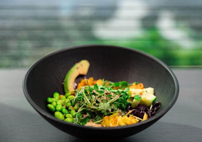 Aufnahem einer frisch zubereitetn Bowl mit Mais, Bohnen, Avocado und Karotten
